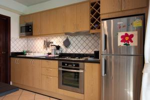 a kitchen with a stainless steel refrigerator with a flower on it at Garden Villa in Bali Residence Mae Phim with Kids Bunk Suite in Ban Bua Phut