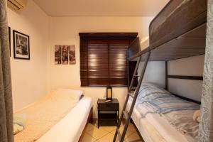 a bedroom with two bunk beds and a lamp at Garden Villa in Bali Residence Mae Phim with Kids Bunk Suite in Ban Bua Phut