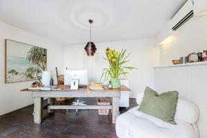 an office with a desk with a computer and a chair at Bay Breeze Boutique Accommodation in Batemans Bay