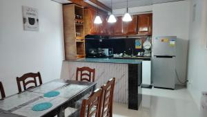a kitchen with a table with chairs and a refrigerator at Jorich home stay in Dumaguete +14 photos