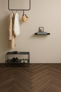 a shelf with shoes and a lamp on a wall at NEW TOWN Boutique Apartments & Parking in Graz