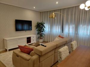 a living room with a large couch and a table at A casa de Aliciña in Sanxenxo