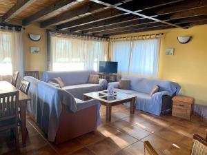 a living room with two couches and a coffee table at Quinta del Quinoto in Pajares de Adaja