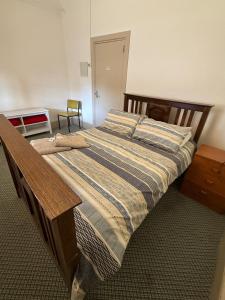 ein Schlafzimmer mit einem Bett mit Holzrahmen in der Unterkunft Riverton Hotel in Riverton