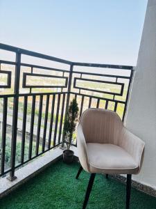 a white chair sitting on a balcony at Apex Hub in Greater Noida +3 photos