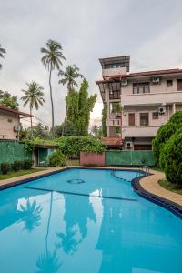 a large blue swimming pool in front of a building at Airport Green View Hotel Katunayake in Andiambalama
