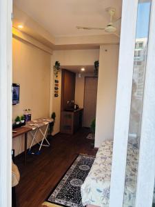 a room with a bed and a desk in it at Apex Hub in Greater Noida
