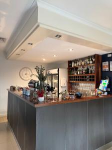 a kitchen with a bar in a room at Bairnsdale International in Bairnsdale