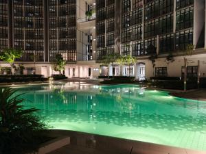 an empty swimming pool in a building at night at Milano8 Condominium Opposite Vivacity in Kuching