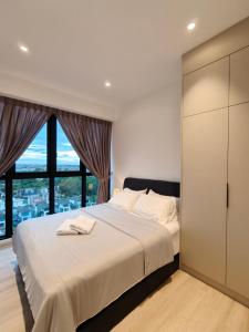 a bedroom with a large bed and a large window at Milano8 Condominium Opposite Vivacity in Kuching
