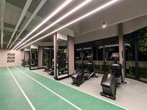 a gym with treadmills and ellipticals in a building at Milano8 Condominium Opposite Vivacity in Kuching