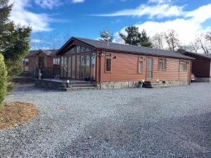 a house with a large driveway in front of it at Rannoch Lodge in Auchterarder