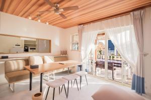 a kitchen and dining room with a table and chairs at Halema in Ichinomiya