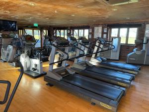 a gym with several treadmills and cardio machines at Cwt Ieir in Ruthin