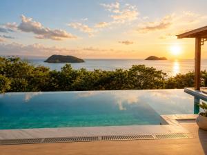 a swimming pool with a view of the ocean at Reen Run Sunset Private Pool Villa in Ko Phangan
