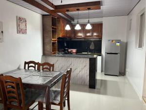 a kitchen with a table and chairs and a refrigerator at Jorich home stay in Dumaguete
