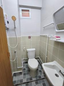 a bathroom with a toilet and a sink at 9TY hotel (ninety hotel) in Bangkok