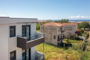 an apartment building with balconies and the ocean in the background at SithoniaRS Sea Nomad Luxury Maisonette in Nikiti