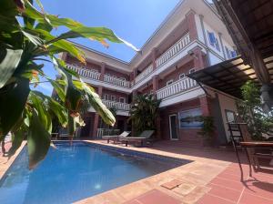 a swimming pool in the courtyard of a house at Monterey Angkor Boutique in Phum Pobos