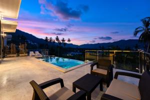 a patio with a view of a pool and mountains at Panorama View Villa in Ban Thung