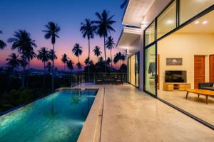 an infinity pool in a house with palm trees at Panorama View Villa in Ban Thung