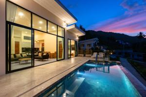 a house with a swimming pool in the backyard at Panorama View Villa in Ban Thung