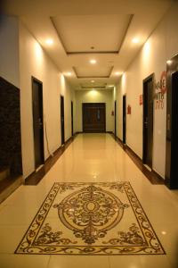 a hallway with a rug on the floor in a building at Hotel Sree7 Inn in George Town