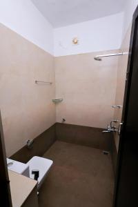 an empty bathroom with a sink and a toilet at ILLIKKALAM Lakeside Cottages Kumarakom Kerala in Kumarakom +97 photos