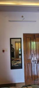 a man taking a picture of a mirror next to a door at Casa Aura in Lucknow +4 photos