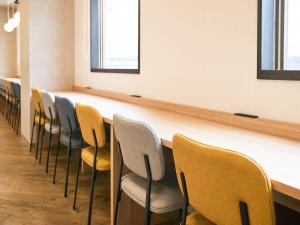 a row of chairs lined up in a room at Comfort Hotel Himeji in Himeji