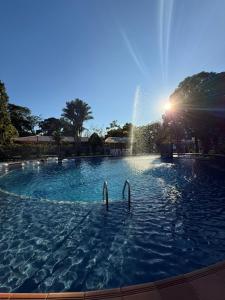 a fountain in the middle of a swimming pool at Finca Hotel La Potranca in Acacías +24 photos