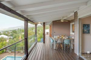 a porch with a table and chairs on a deck at Villa Stella in Saint-Leu