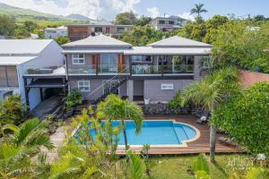 an aerial view of a house with a swimming pool at Villa Stella in Saint-Leu