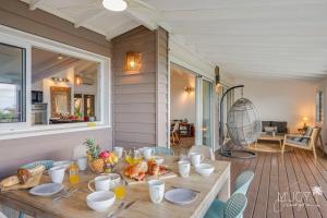 a table with food on it on a porch at Villa Stella in Saint-Leu