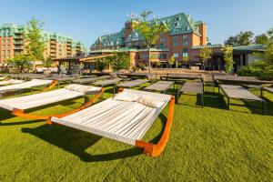 a row of beds on the grass in a park at Chateau Cartier Hotel & Resort, an Ascend Collection Resort in Gatineau
