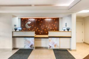 a lobby with a reception desk in a building at Comfort Inn & Suites Saint Louis Lafayette Square in Saint Louis