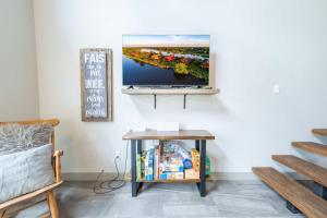 a living room with a tv on a wall at Spa Relaxation & Adventure - Lapointe du Lac in Saint-Gérard
