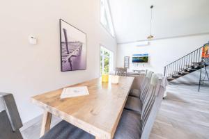 a dining room with a wooden table and a couch at Spa Relaxation & Adventure - Lapointe du Lac in Saint-Gérard +61 photos