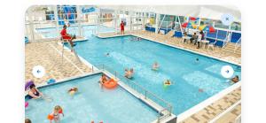 a pool on a cruise ship with people in it at Kestrel Court 16 in Scratby