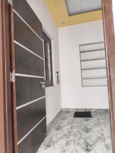 a room with a door and a tile floor at Bari Mata home ste in Lakāwās