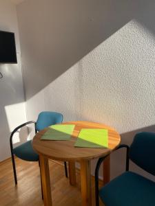 a table in a room with blue chairs and a table at Haus Panorama in Tylkowo