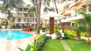 a resort with a swimming pool and a building at Eternal wave by HappyInch in Calangute