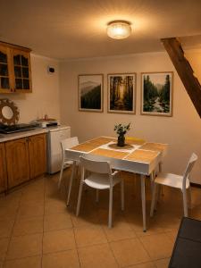 a kitchen with a dining room table and chairs at Przystań Kownatki in Kozłowo +40 photos