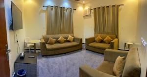 a living room with two couches and a tv at ABHASKY Serviced Apartmentsشقق مخدومة اقتصادي in Abha
