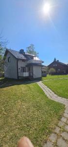a person standing in front of a house at Arctic House Kemi 7 GUEST, outdoor tentsauna Experience in Kemi