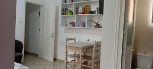 a small table and chair in a small room at Enki's Garden in Tirana