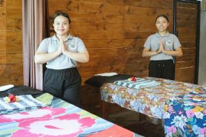 two women are standing in a room with theirselves praying at Bali Hidden Lemukih in Sawan +78 photos