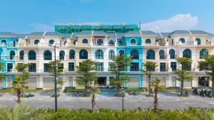 a large building with trees in front of it at Cactus Villa in Dong Hoi