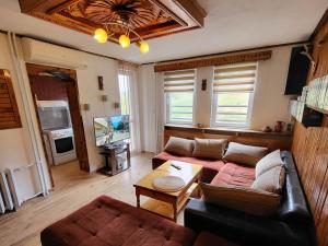 a living room with a couch and a table at Вила Беевски in Gela