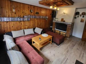 a living room with a red couch and a table at Вила Беевски in Gela